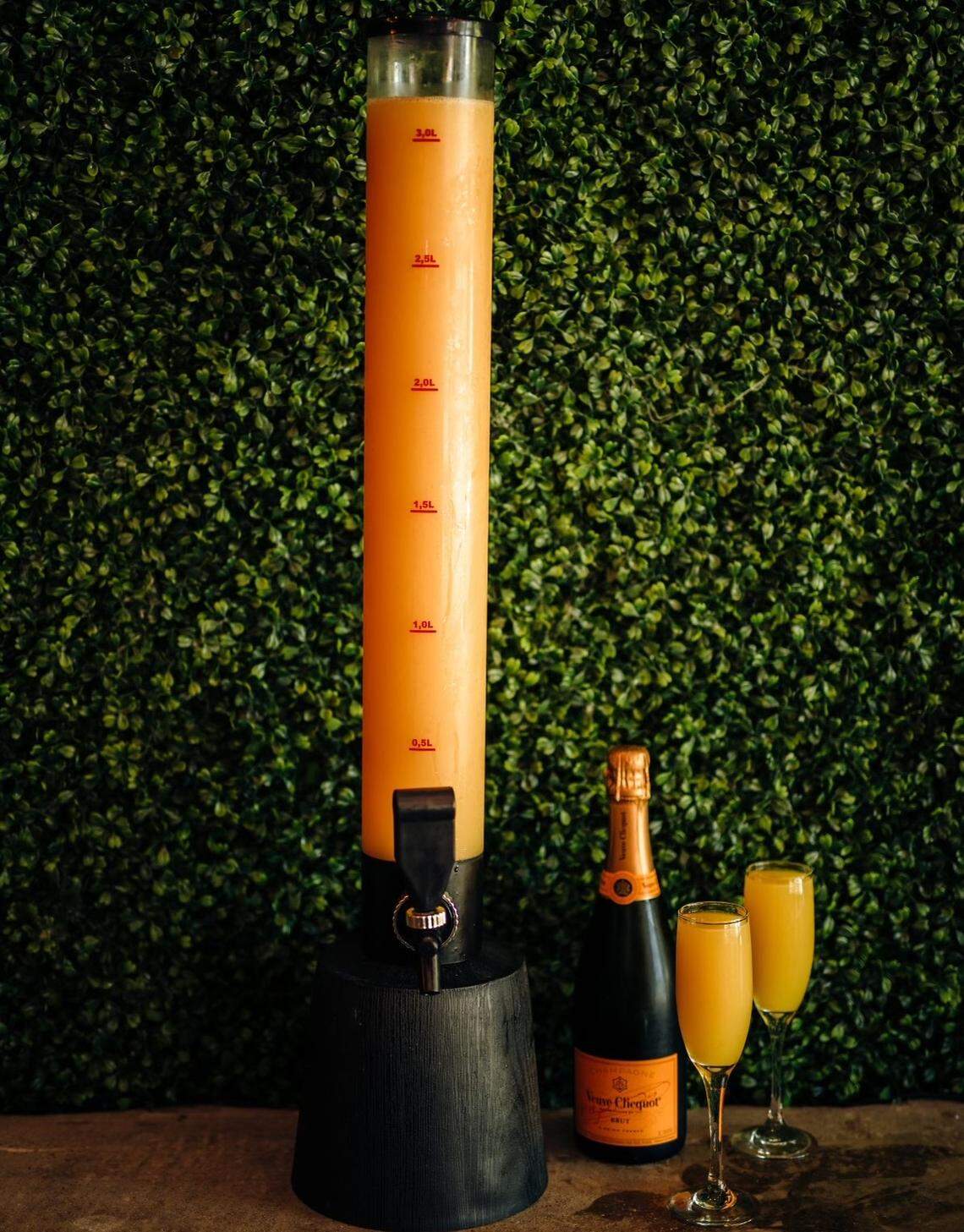 Behold the mimosa tower, which holds three bottles of champagne and the juice of your choice.