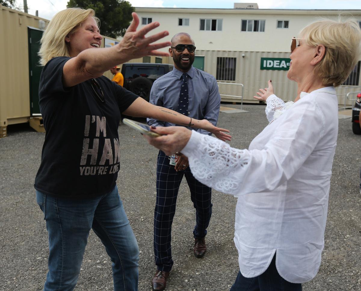 Dr. Hansel Tookes watches as two mothers, bonded both by the grief of losing sons to overdoses and the hope of helping others, meet for the first time in the parking lot of the IDEA Needle Exchange in Miami.