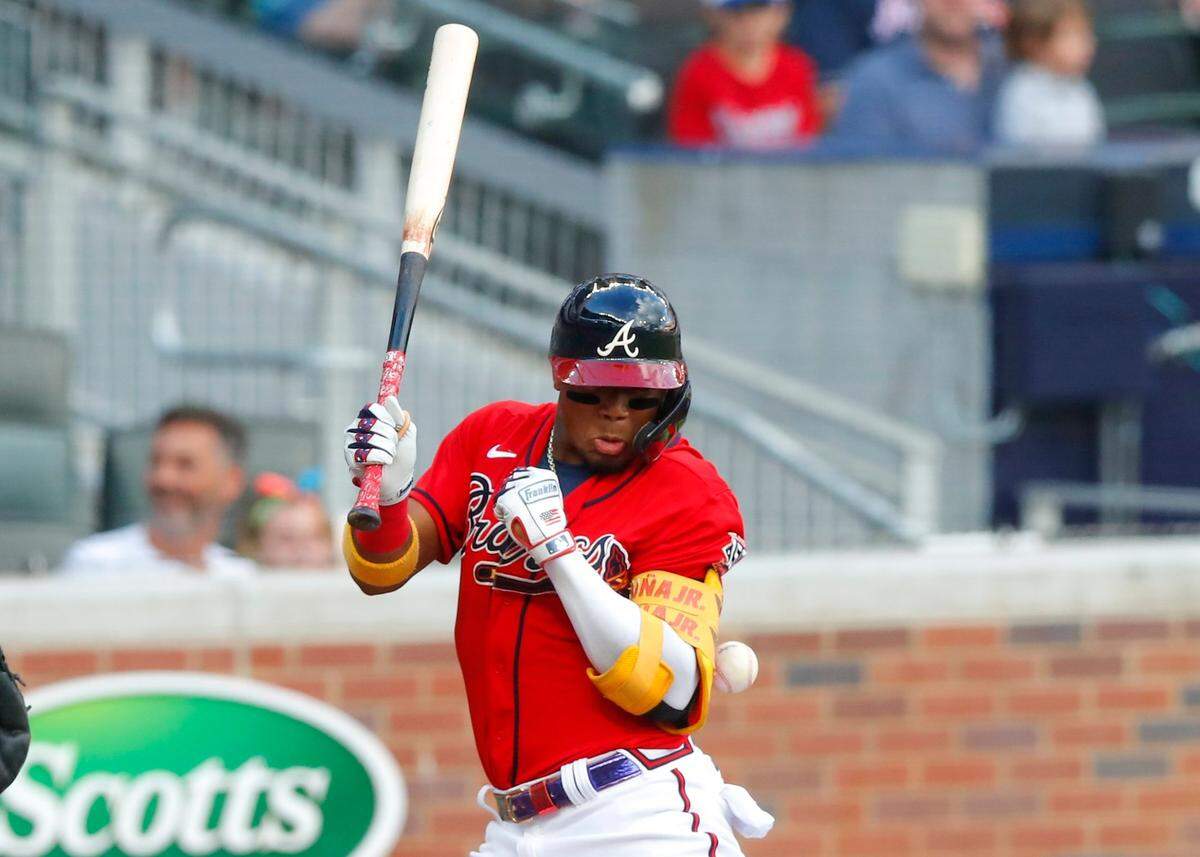 Ronald Acuna Jr. #13 of the Atlanta Braves is hit by the first pitch in the first inning of an MLB game against the Miami Marlins at Truist Park on July 2, 2021 in Atlanta, Georgia.