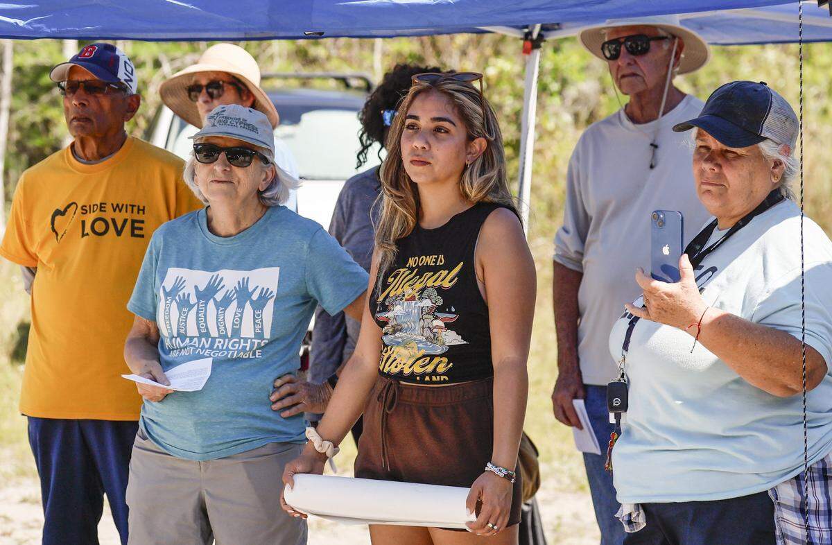 Arianne Betancourt, at center, joins protesters during a May Day Rally outside of Alligator Alcatraz located at the Dade-Collier Training and Transition Airport in the Florida Everglades, Ochopee, Florida, on Friday, May 1, 2026. Her father, Justo Betancourt, currently being detained at Alligator Alcatraz.