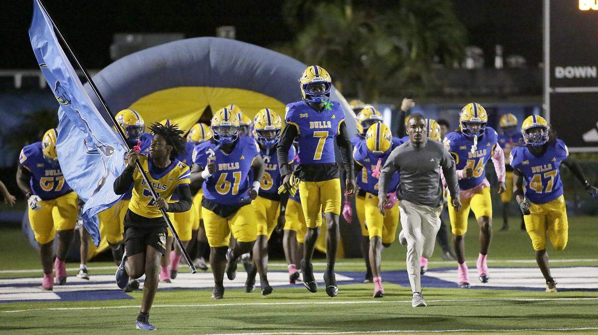 Northwestern team take the field for the game against Palmetto  on Friday, October 17, 2025 at Traz Powell Stadium in Miami.  Andrew Uloza / for Miami Herald