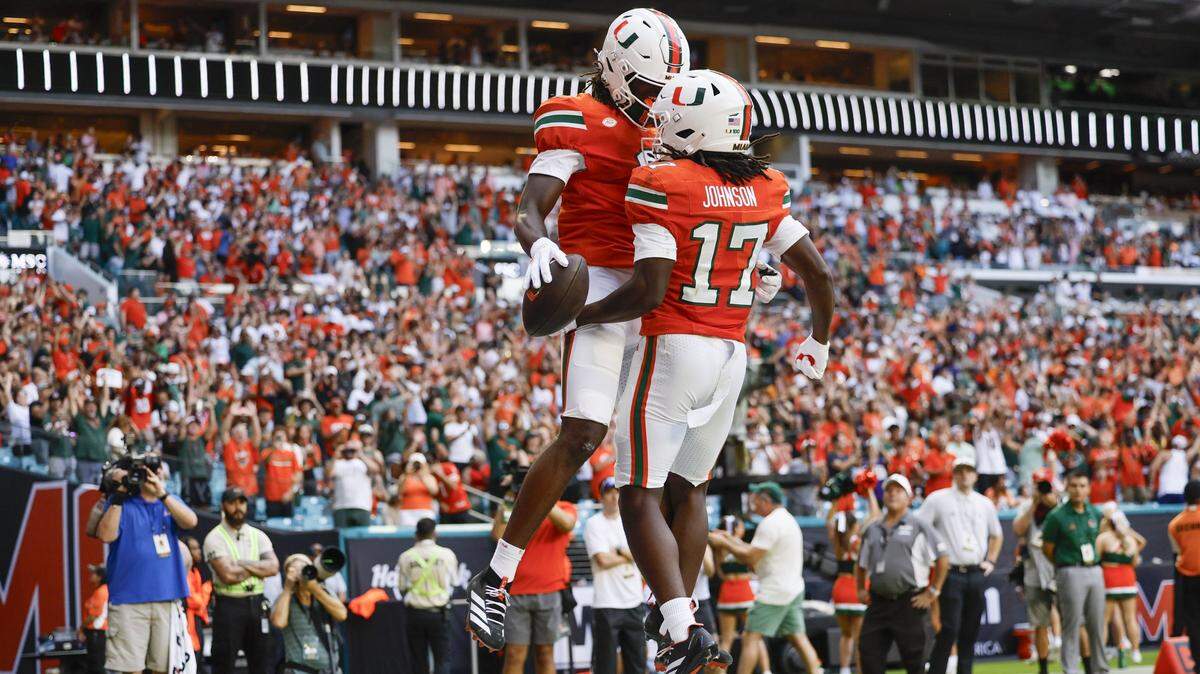 Miami Hurricanes wide receiver Joshua Moore (3) celebrates his touchdown with wide receiver Tony Johnson (17) in the endzone after Moore scores in the first half of their NCAA football game against the South Florida Bulls at Hard Rock Stadium in Miami Gardens, Florida, on Saturday, September 13, 2025.