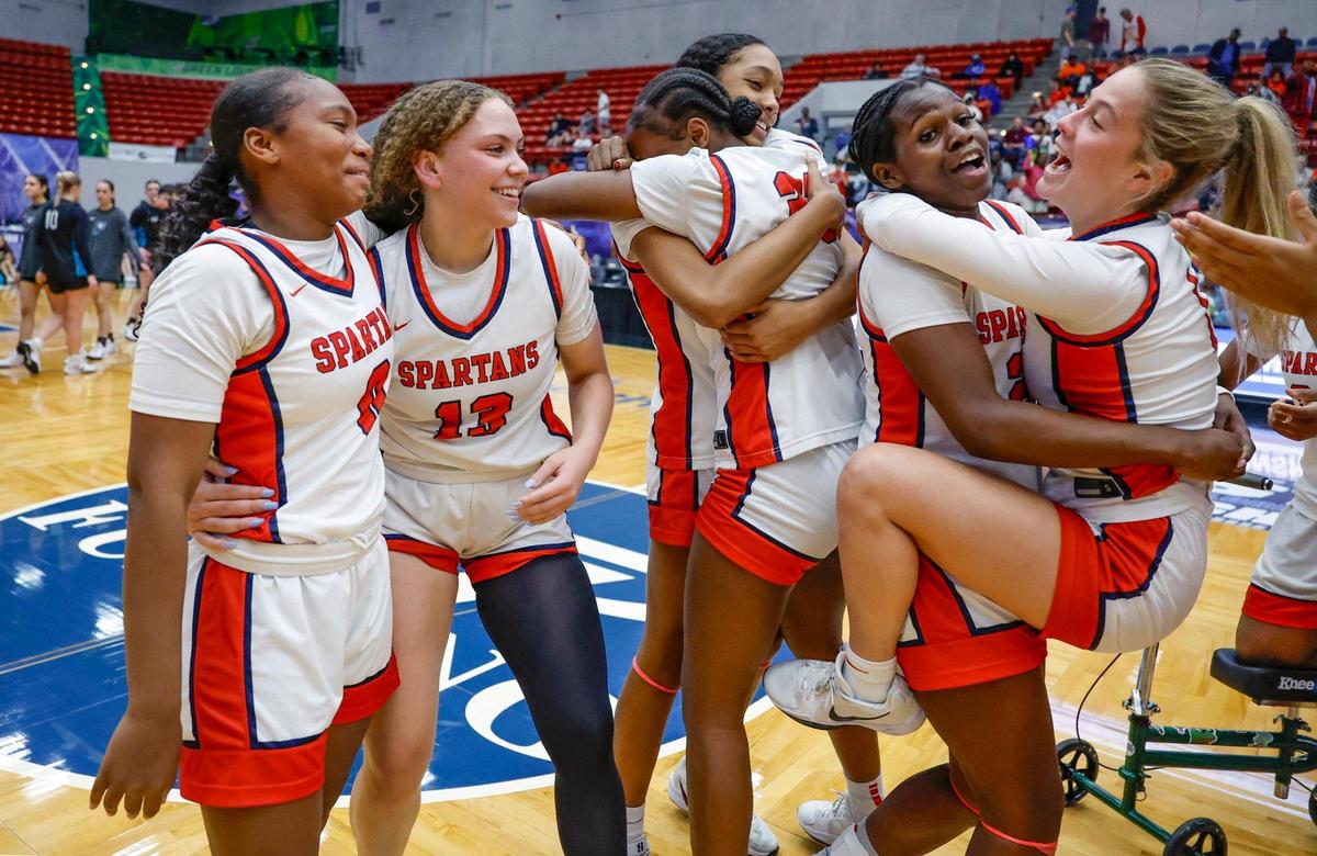Miami Country Day’s Arianna Robinson (0), Jalynn Belton (13), Kennedy Deal (21) and Josephine Ifergan (1), at front left to right, celebrate with teammates on the court after defeating Providence School for the FHSAA Class 2A Girls High School Basketball State Championship at the RP Funding Center in Lakeland, Florida on Saturday, March 1, 2025.