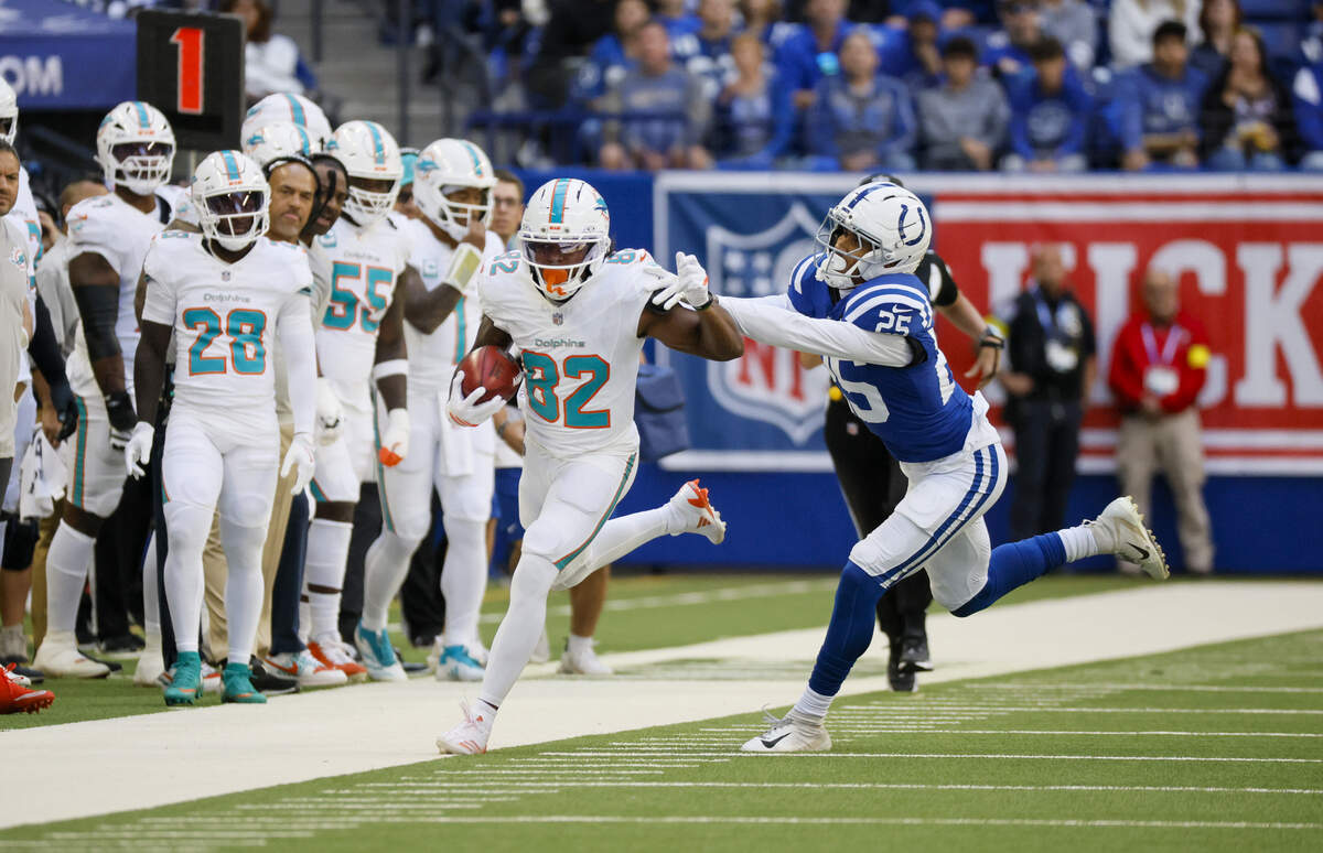 Miami Dolphins wide receiver Dee Eskridge (82) carries the ball as Indianapolis Colts safety Rodney Thomas II (25) closes in during the first half of an NFL game at Lucas Oil Stadium on Sunday, September 7, 2025, iIndianapolis, Indiana.