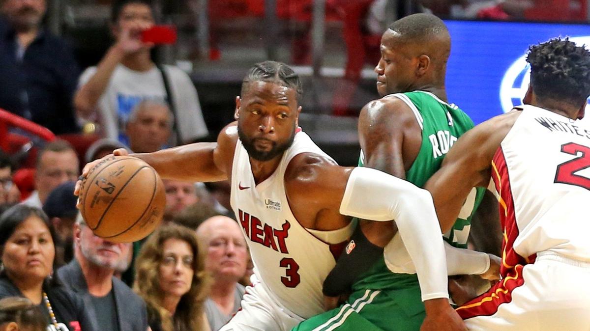 Miami Heat Dwyane Wade (3) dribbles around Boston Celtics Terry Rosier (12) in the second quarter at the AmericanAirlines Arena in Miami, Florida, Wednesday, April, 3, 2019.