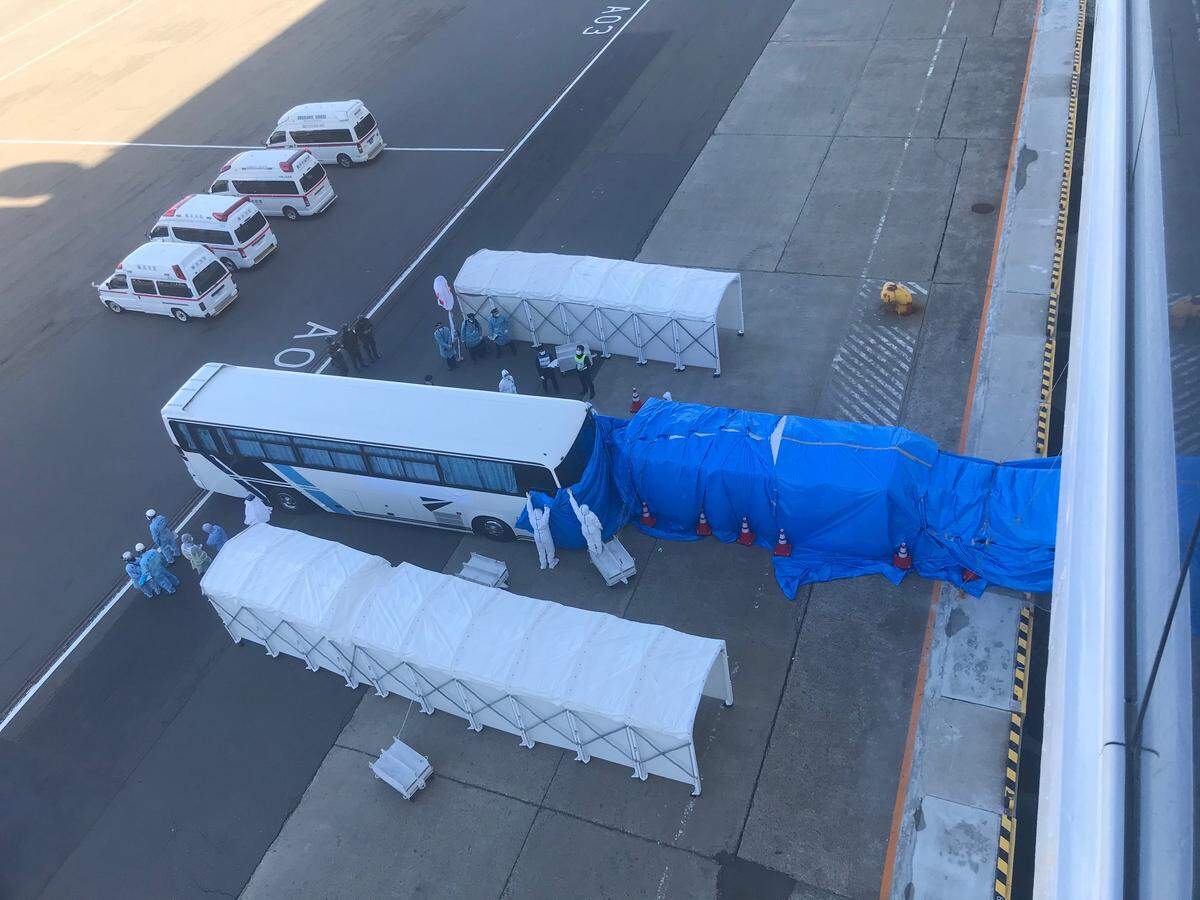 Tunels extend from the Diamond Princess cruise ship to a bus alongside the ship on February 11, 2020. The cruise ship has been quarantined in Yokohama, Japan since Feb. 4.