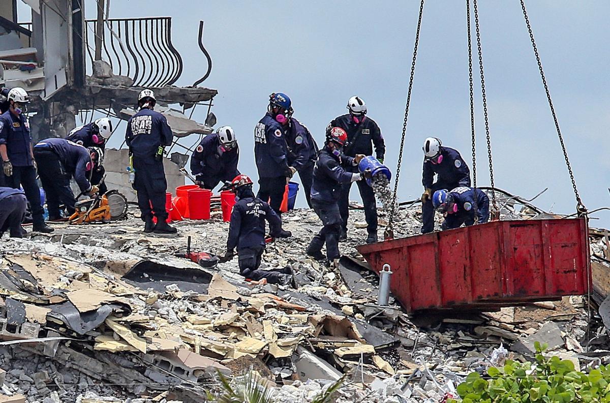 South Florida Urban Search and Rescue team members look through the rubble of Champlain Towers South after the condo collapsed on June 24.