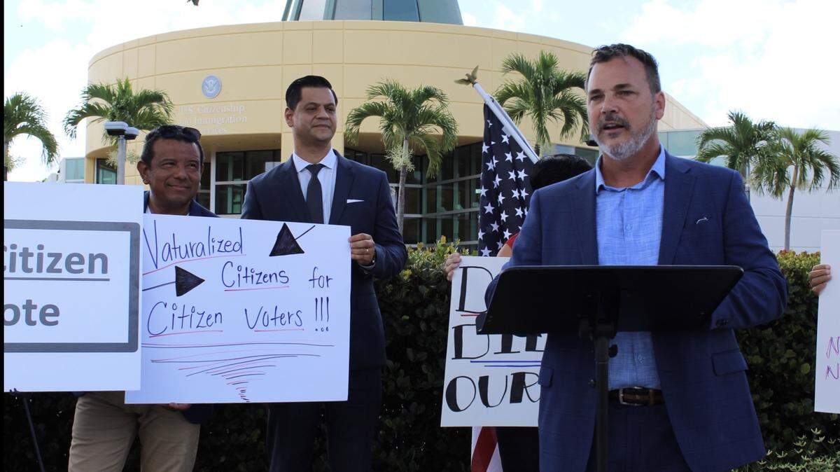 John Loudon speaks in Miami on July 17, 2019, to deliver the final signatures for Florida Citizen Voters, which announced it has collected 1.5 million signatures. With him is Gabriel Alfonzo, a naturalized citizen from Venezuela, and Jose Montas, a naturalized citizen from Dominican Republic.