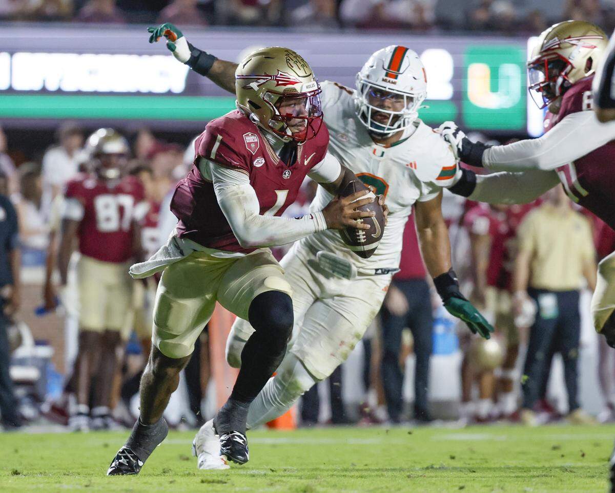 Miami Hurricanes defensive lineman Akheem Mesidor (3) chases Florida State Seminoles quarterback Tommy Castellanos (1) during the second half of their NCAA game at Doak Campbell Stadium in Tallahassee, Florida, on Saturday, October 4, 2025.