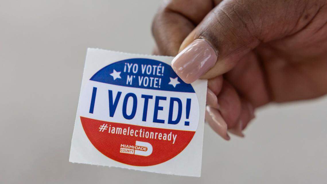 A voter holds her sticker after casting her ballot at the North Dade Regional Library on Aug. 20 in Miami Gardens.