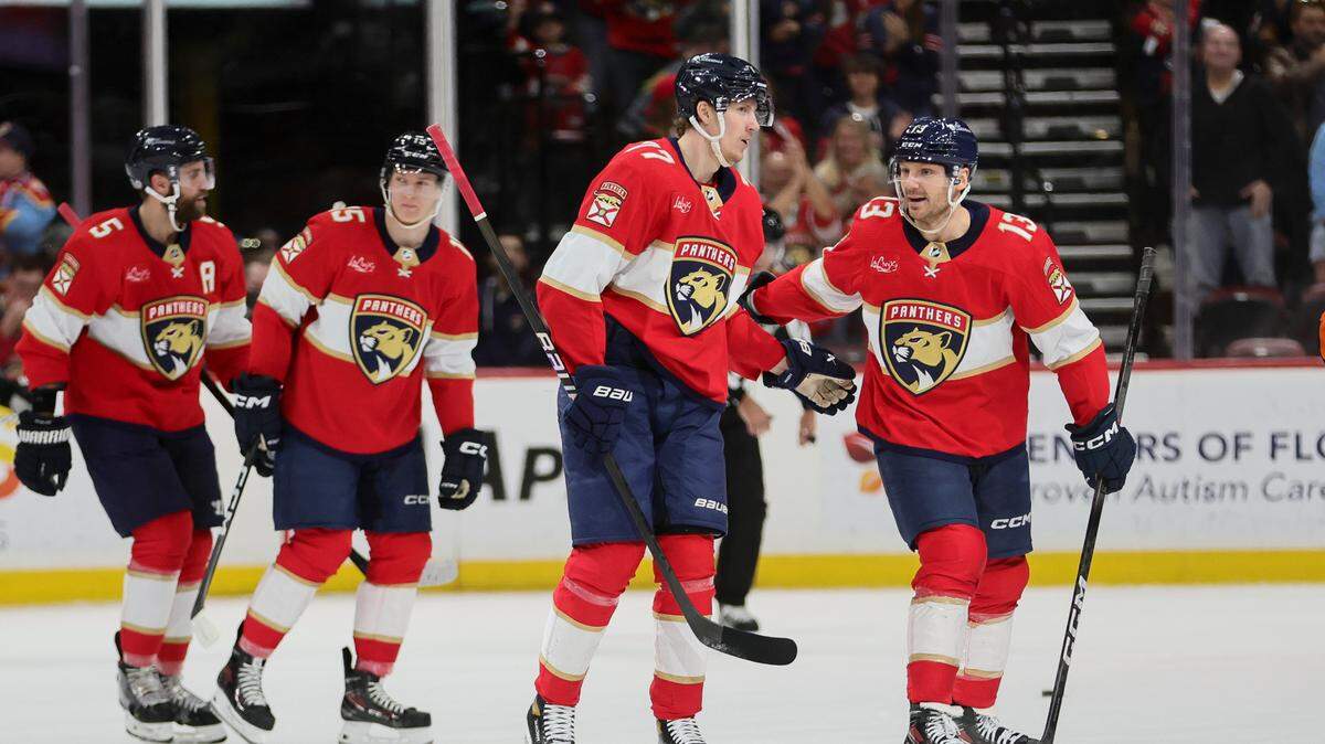 Jan 15, 2024; Sunrise, Florida, USA; Florida Panthers center Sam Reinhart (13) celebrates with center Evan Rodrigues (17) after scoring against the Anaheim Ducks during the first period at Amerant Bank Arena. Mandatory Credit: Sam Navarro-USA TODAY Sports