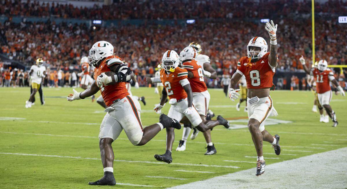 Miami Hurricanes defensive lineman Rueben Bain Jr. (4) runs with the ball after he intercepted the ball against Notre Dame Fighting Irish in the second half of their NCAA football game at Hard Rock Stadium on Sunday, Aug. 31, 2025, in Miami Gardens, Fla.