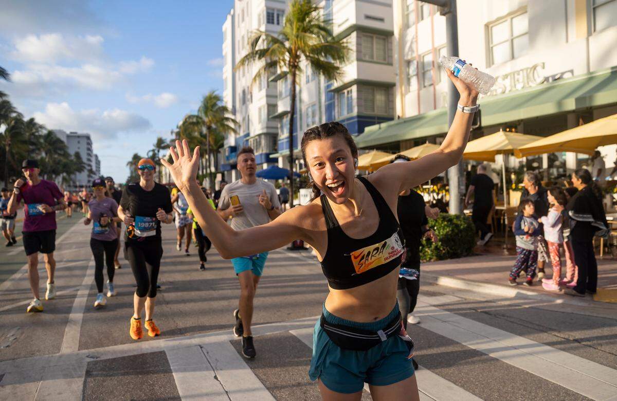 A runner reacts while making her way down Ocean Drive while participating in the Life Time Miami Marathon and Half Marathon on Sunday, Jan. 29, 2023, in Miami Beach, Fla.