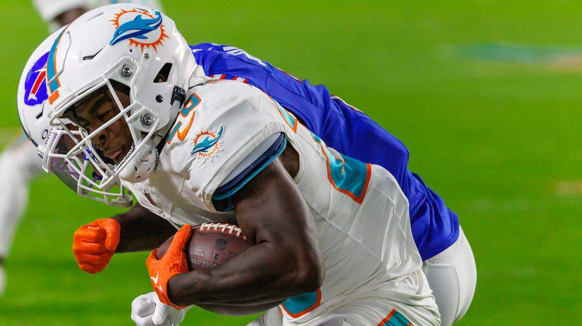 Buffalo Bills cornerback Taron Johnson (7) tackles Miami Dolphins running back De’Von Achane (28) during first half of an NFL football game at Hard Rock Stadium on Sunday, Jan. 7, 2024 in Miami Gardens, Fl.
