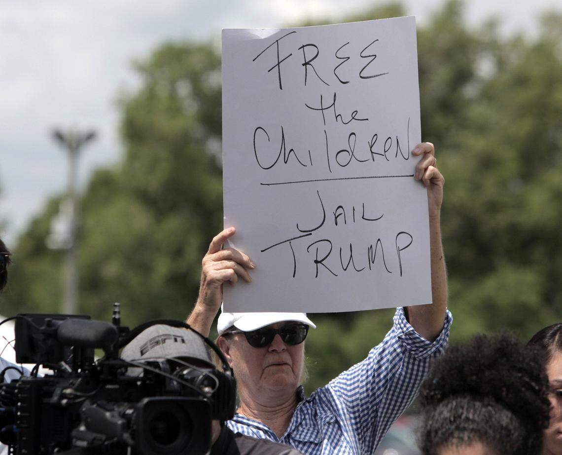 A protestor holds up a sign during a news conference outside the compound in Homestead housing unaccompanied minors and some children separated from their migrant parents at the border.