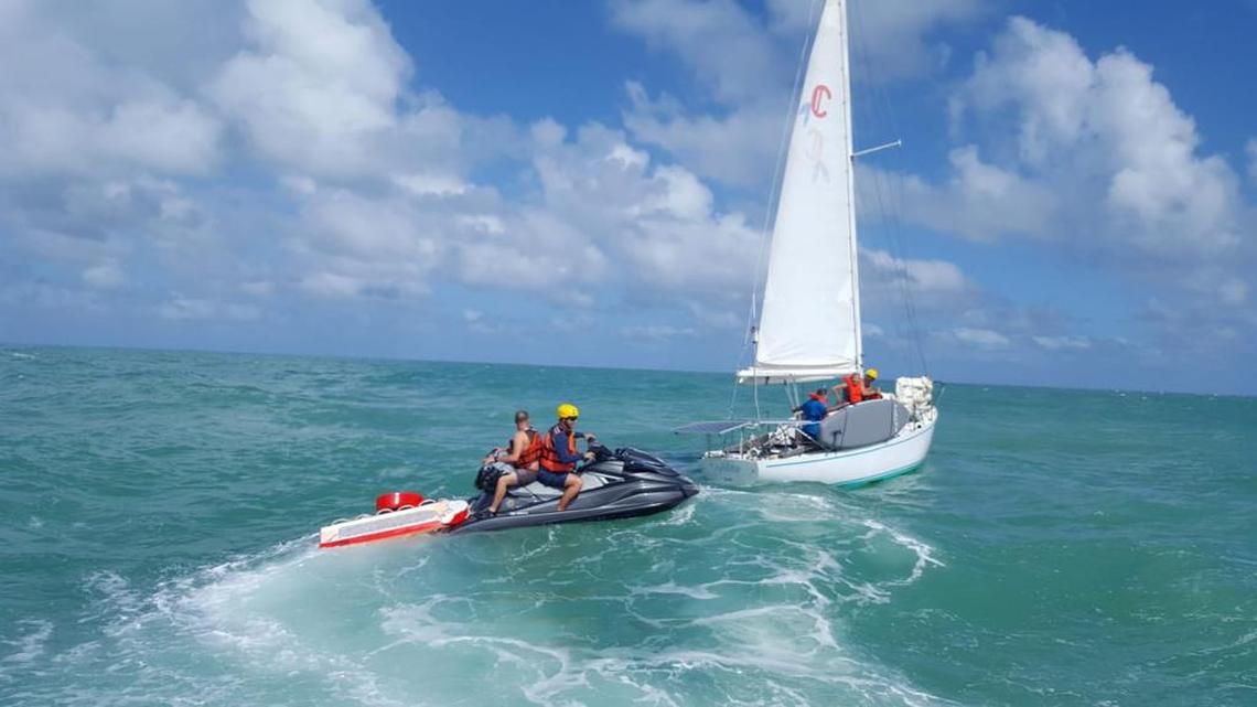 Miami-Dade Ocean Rescue lifeguards aiding a boater in trouble before the beach closures mandated by the coronavirus pandemic.