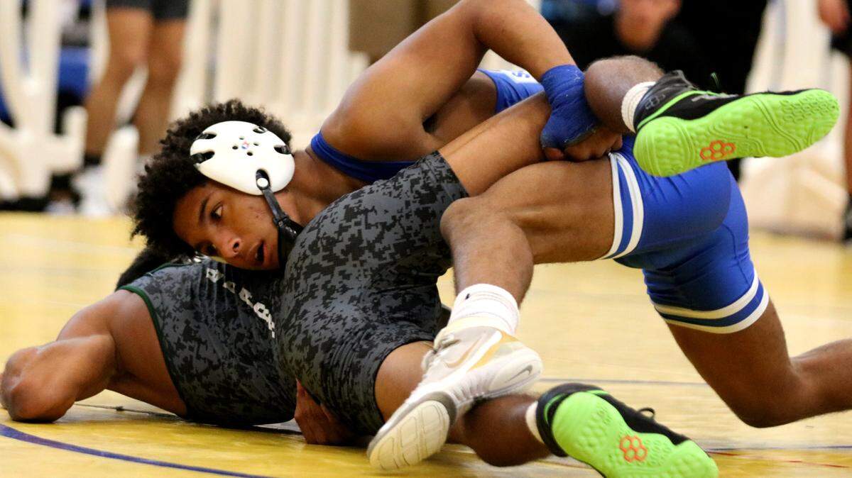 South Dade freshman Nathaniel Williams takes control over Palmetto Ridge junior Bernardo Barnhart on his way to a 5-2 victory during a 120-pound match in the Class 3A semifinals at the FHSAA Dual State Championships on Saturday at Osceola High School in Kissimmee.