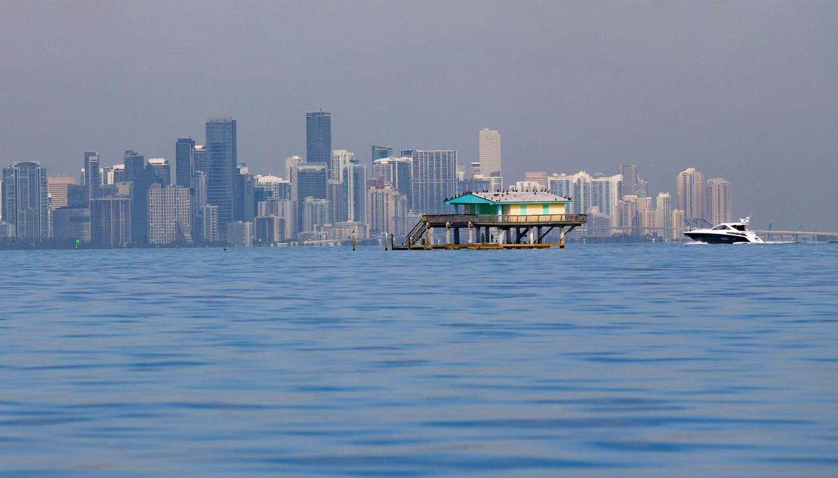 The Miami city skyline is seen in the background of one of the six remaining wood stilt houses known as Stiltsville, located one mile south of Cape Florida on Biscayne Bay on Friday, January 15, 2021.
