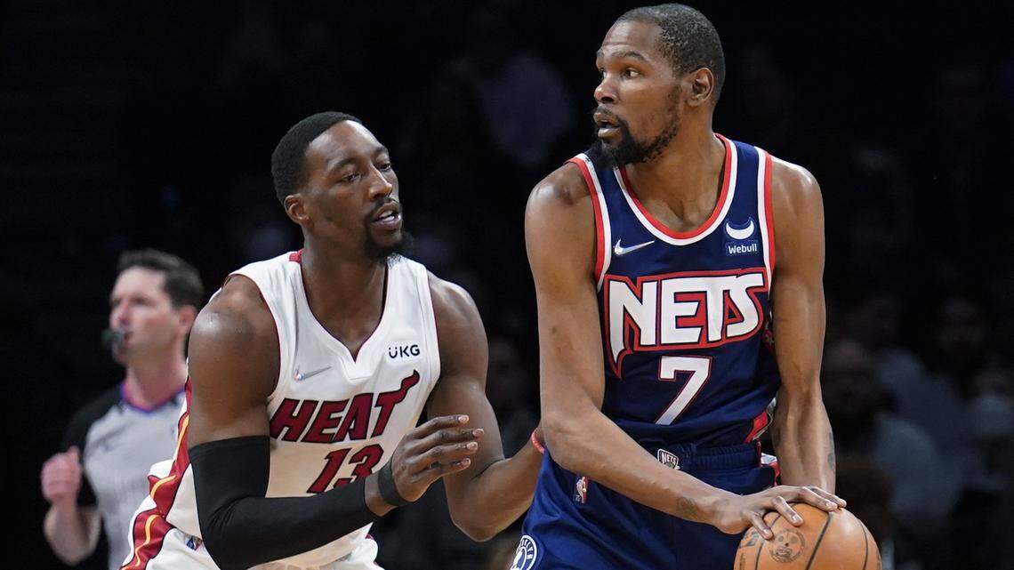 Brooklyn Nets forward Kevin Durant (7) looks to pass the ball as Miami Heat center Bam Adebayo (13) defends during the first half of an NBA basketball game Thursday, March 3, 2022, in New York.
