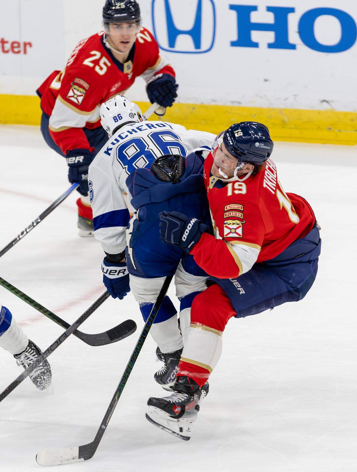 Tampa Bay Lightning right-wing Nikita Kucherov (86) makes a hit against Florida Panthers left-wing Matthew Tkachuk (19) during first-period action in an NHL game held at Amerant Bank Arena on Monday, December 23, 2024, in Sunrise, Florida.”
