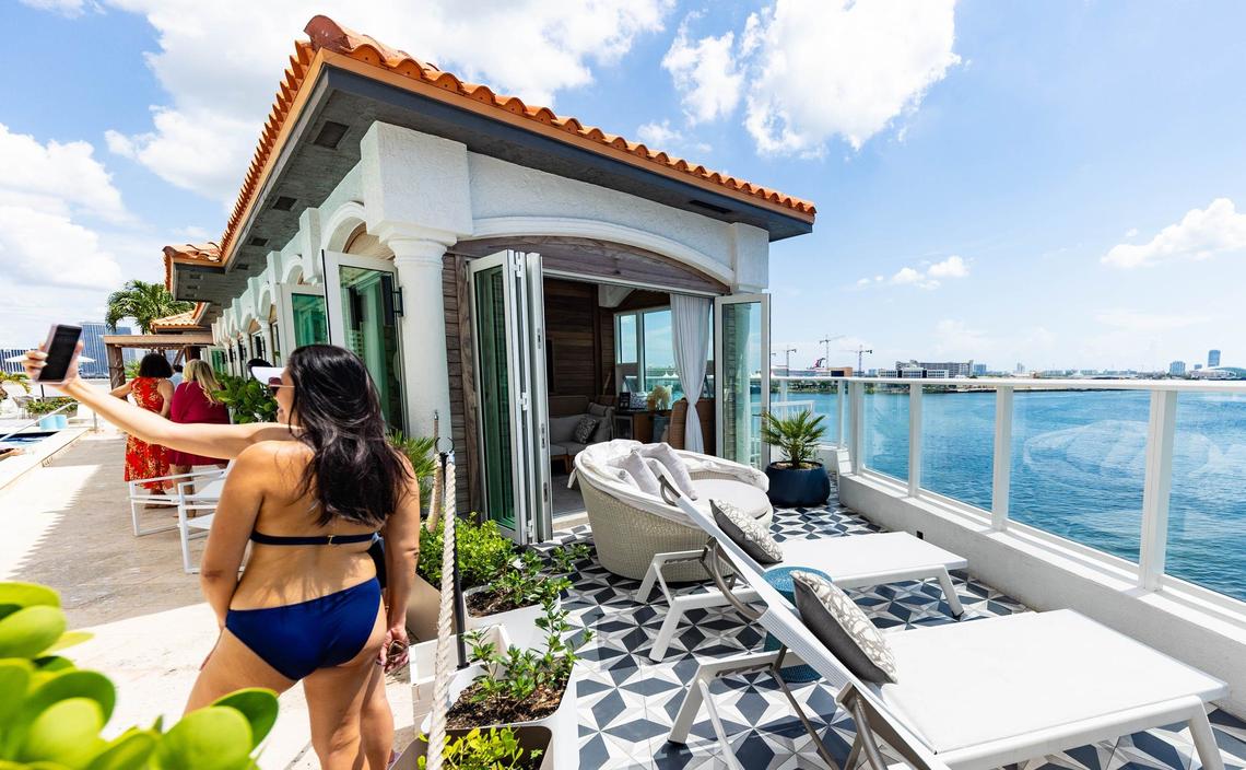 Visitors at the InterContinental Hotel downtown take a selfie next to the cabana patio area facing the water on Thursday, August 15, 2024 in Miami, Fla.