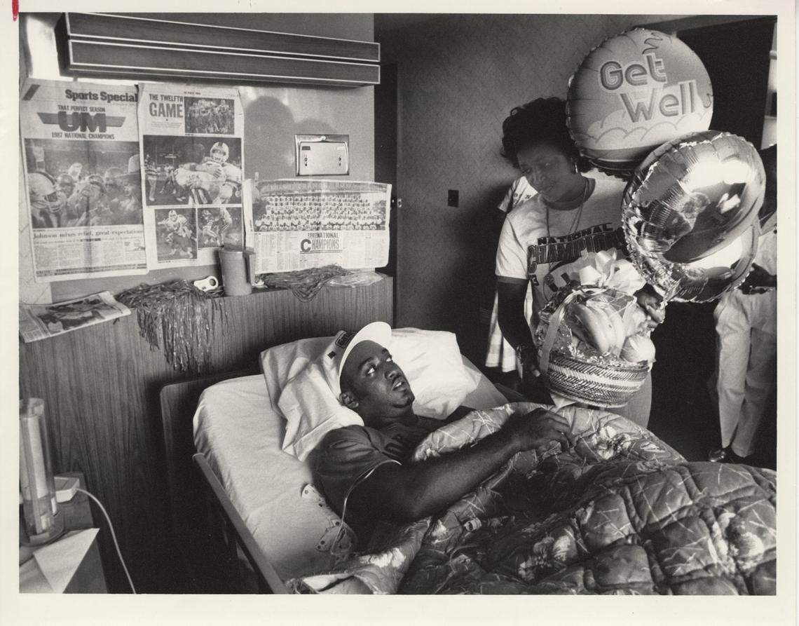 In this file photo from Jan. 3, 1988, Melvin Bratton takes a glance as his mother Gloria Stewart shows one of many get-well gifts he had received after he blew out his knee while playing a UM championship game in the Orange Bowl. It was soon after he and his teammate Alonzo Highsmith discovered their shared love of The Big Cheese Italian restaurant in South Miami.