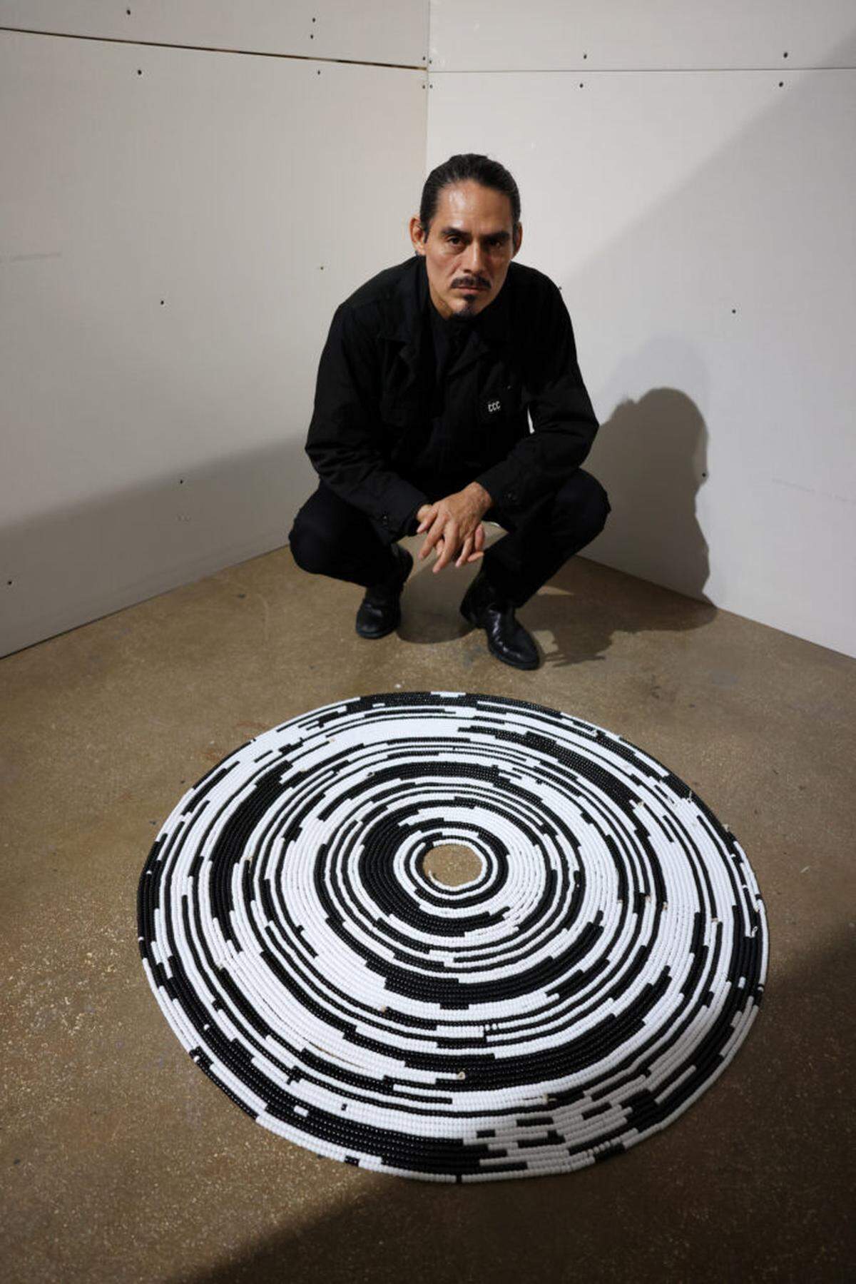 William Cordova with a work from his installation at Locust Projects.