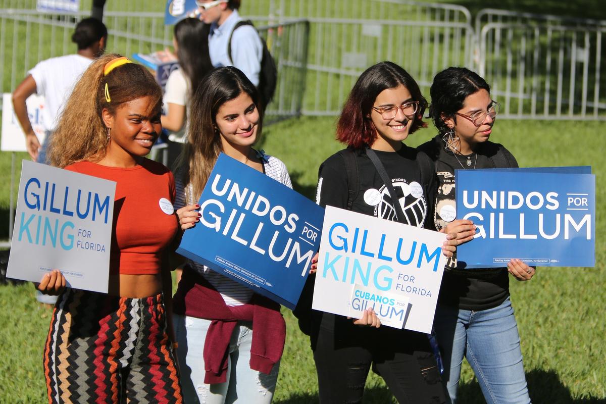 FIU/Academy for Advanced Academics dual enrollment students, from left, Chukwudumebi Enemor, Sabrina Prado, Samantha Milo and Nicole Mazo-Roa hold signs in support of Andrew Gillum, the Democratic candidate for governor, during a Vote Early, Vote Loud Rally on FIU’s Graham Center Lawn Thursday morning, Oct. 25, 2018.