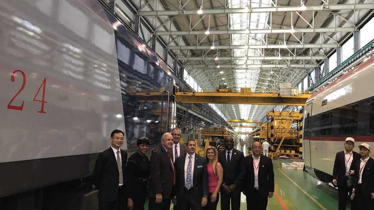 A photo taken of the Miami-Dade trade delegation to China during a tour of CRRC’s trackless train factory. Miami-Dade Mayor Carlos Gimenez stands third from left.