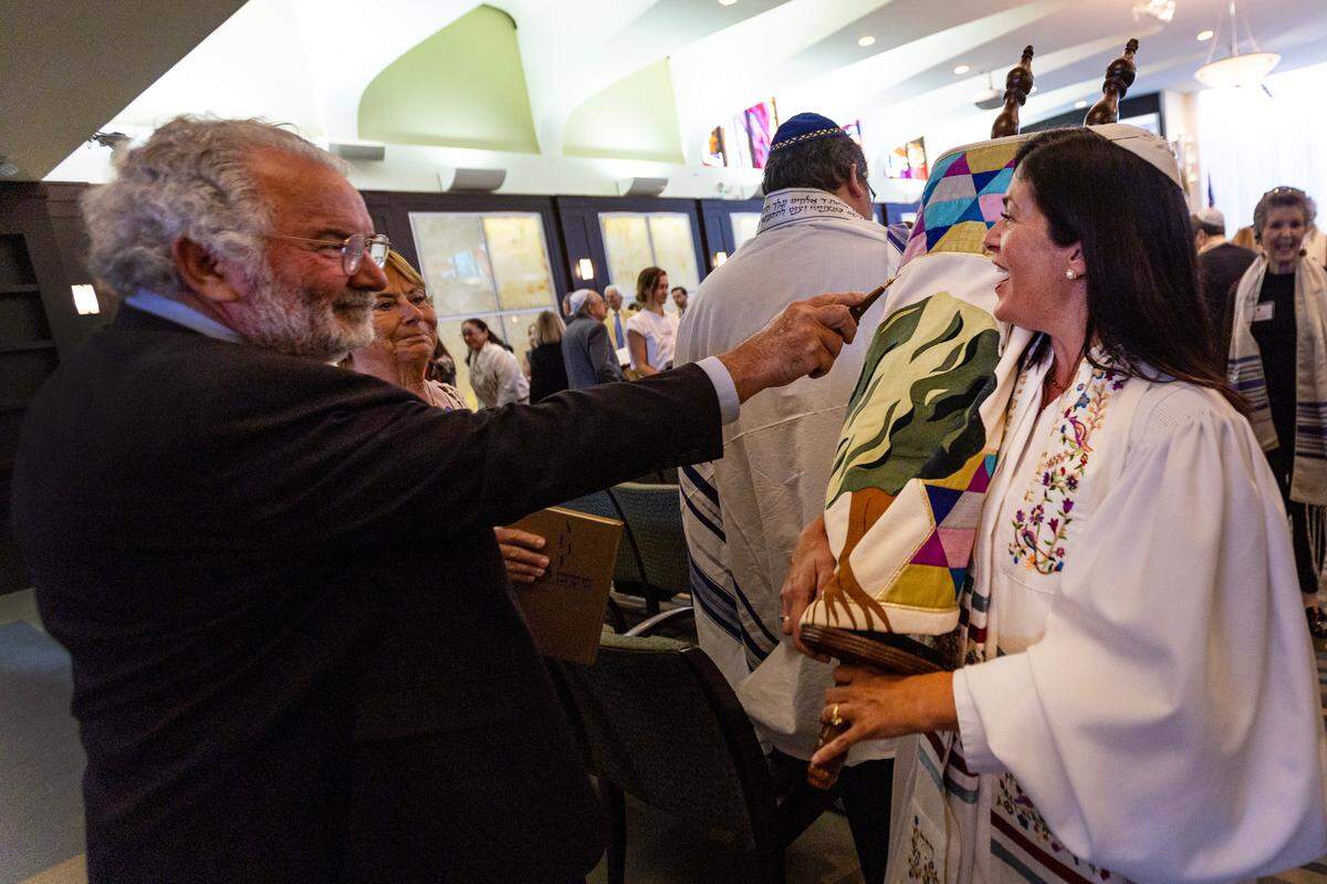 Temple Judea Rabbi Judith Lazarus Siegal parades the Torah during the ‘hakafah,’ the Jewish tradition of walking or encircling around a a religious object.