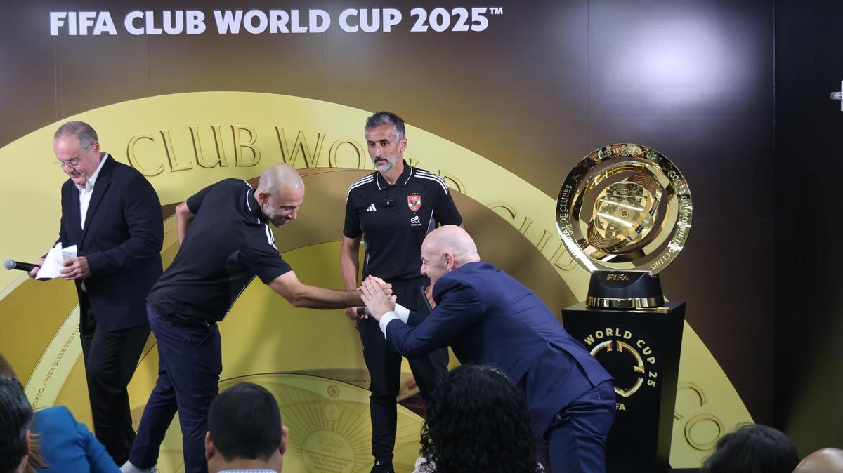 Inter Miami coach Javier Mascherano, left, reaches to greet FIFA president Gianni Infantino, right, while Al Ahly coach Jose Riveiro, looks on as FIFA held its media preview for the Club World Cup at the FIFA Miami headquarters in Coral Gables, Florida on Tuesday, May 10, 2025.