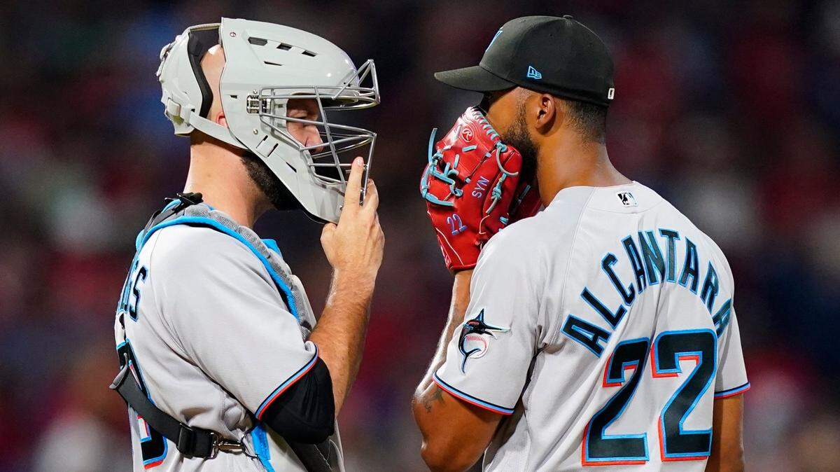 Miami Marlins pitcher Sandy Alcantara, right, and catcher Jacob Stallings talk during the sixth inning of a baseball game against the Philadelphia Phillies, Wednesday, Aug. 10, 2022, in Philadelphia. (AP Photo/Matt Slocum)