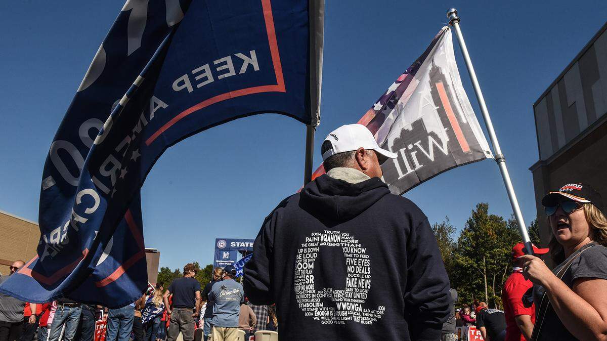 A person wears a QAnon sweatshirt during a pro-Trump rally in October in New York. QAnon traffics in conspiracy theories.