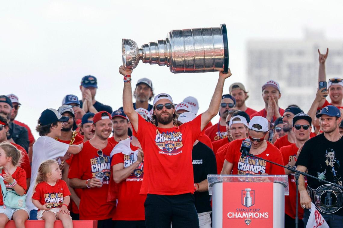 Florida Panthers defenseman Aaron Ekblad hoists the Stanley Cup as teammates cheer on stage during the team’s Stanley Cup victory parade and rally along A1A in Fort Lauderdale, Florida, on Sunday, June 22, 2025.