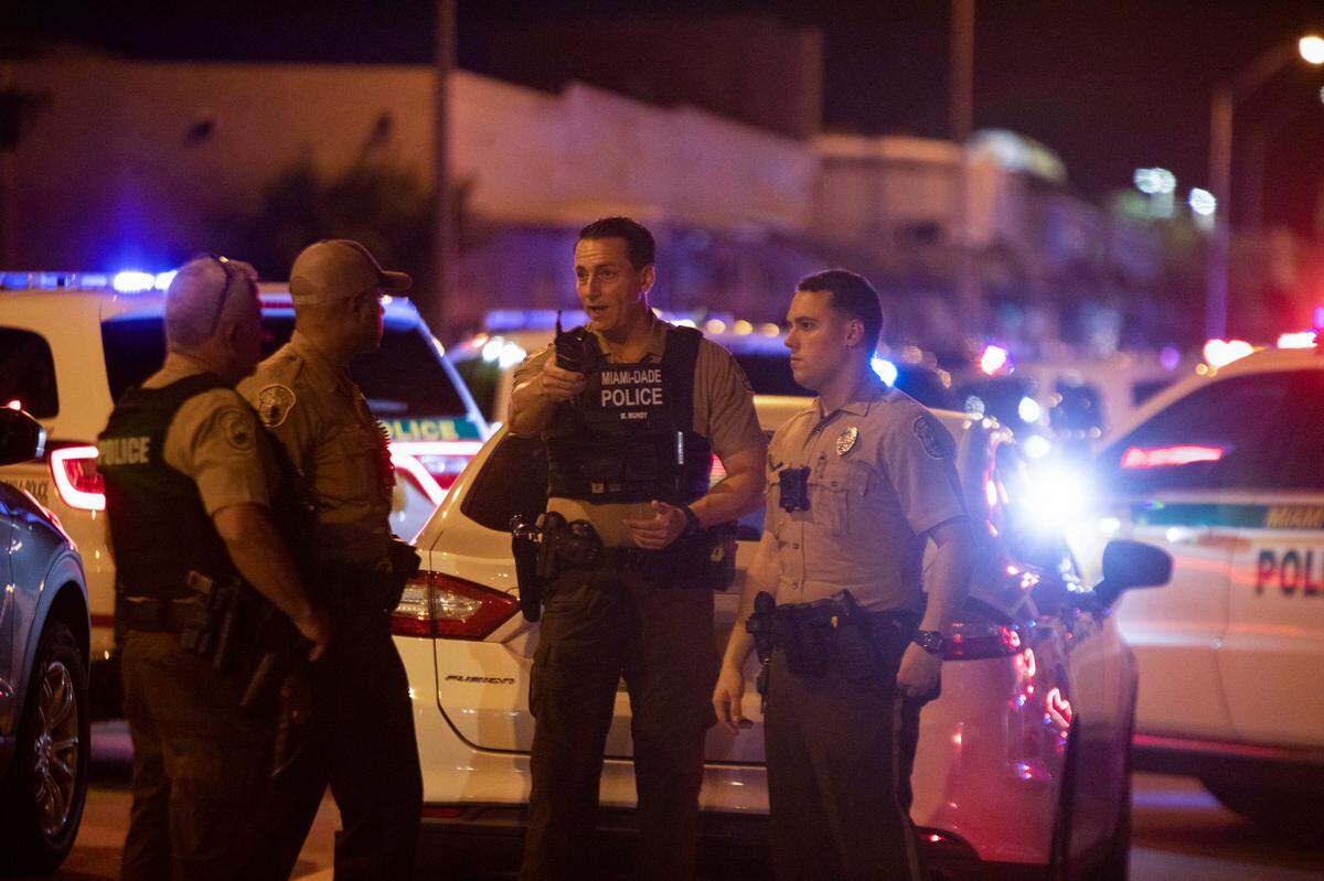 Miami-Dade Police work a crime scene around Northwest 62nd Street and Seventh Avenue in Miami, Florida on Monday, June 15, 2022. A Miami-Dade police officer was shot after a car chase in Liberty City on Monday night, multiple law-enforcement sources said.