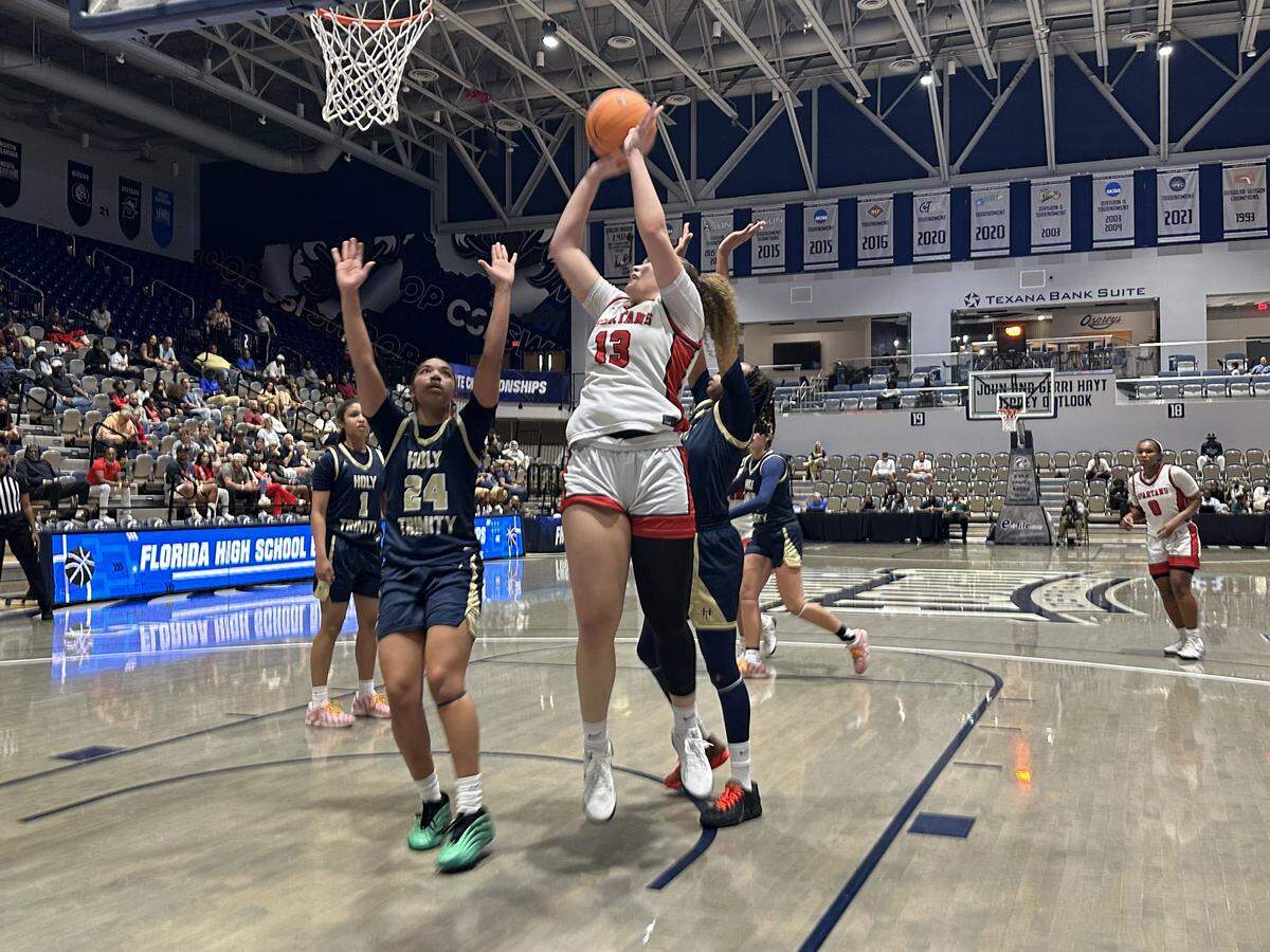 Miami Country Day’s Jalynn Belton goes up for a layup in traffic during Saturday’s Class 2A girls’ basketball state championship game at UNF Arena in Jacksonville, Fla.