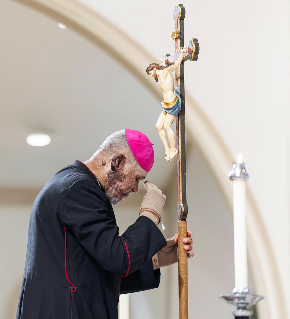 Haitian Bishop Pierre-André Dumas prays during a Good Friday service at the Cathedral of St. Mary on Friday, April 18, 2025, in Miami, Fla.