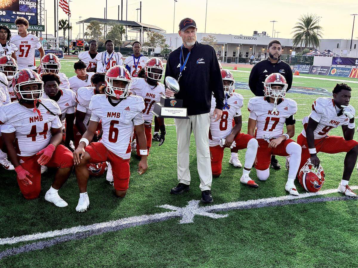 North Miami Beach head football coach Jeff Bertani holds the second-place trophy from the Class 1A-3A Florida Invitational Tournament championship game on Dec. 4, 2025, at The Range at H.G. Morse Stadium in The Villages, Florida.