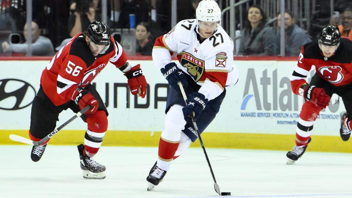 Oct 16, 2023; Newark, New Jersey, USA; Florida Panthers center Eetu Luostarinen (27) skates with the puck as New Jersey Devils left wing Erik Haula (56) pursues during the third period at Prudential Center.