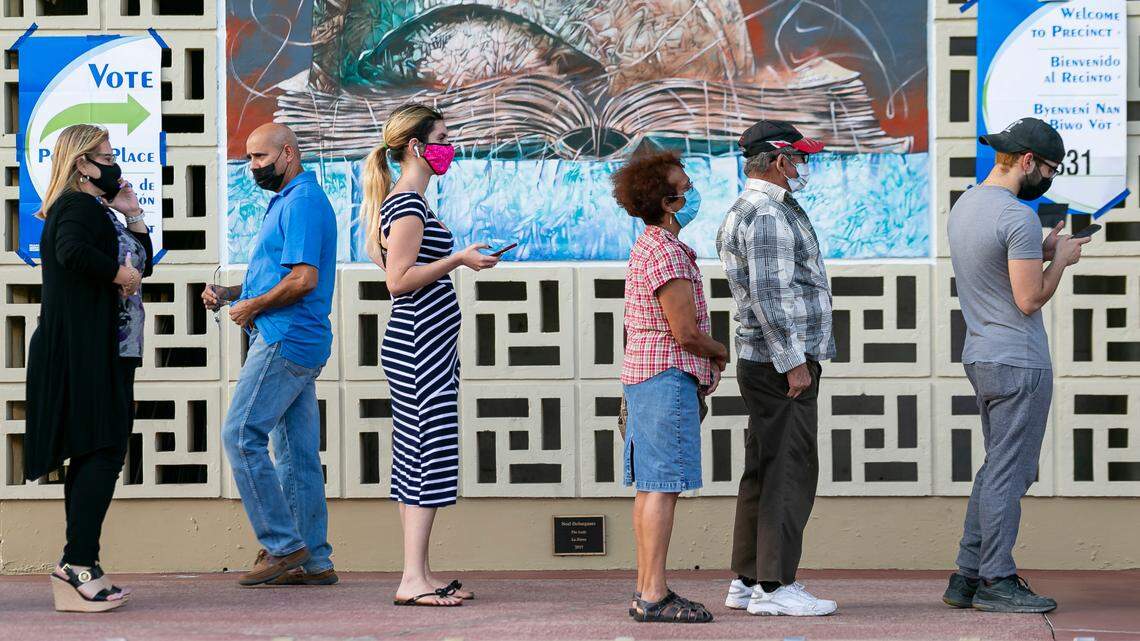 People wait in line to vote at the John F. Kennedy Library in Hialeah, Florida, during the general election on Tuesday, November 3, 2020.