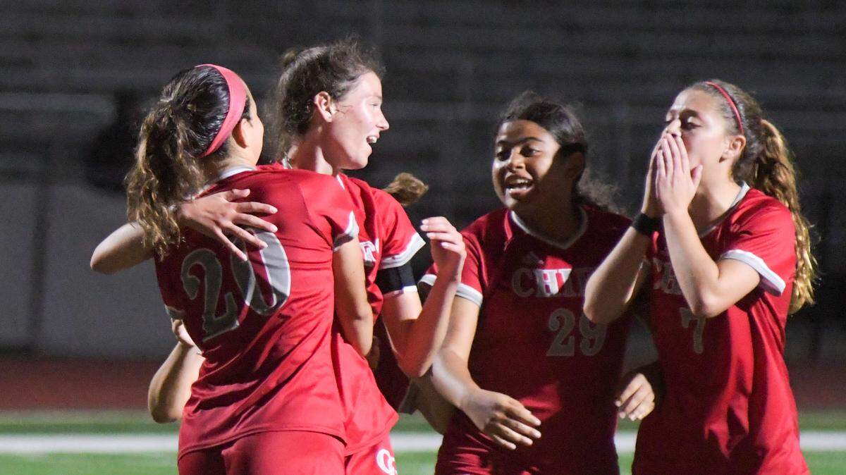 Cardinal Gibbons players celebrate after Macy Berg (second from left) scores on a penalty kick in a regional quarterfinal against MAST Academy on Tuesday, Feb. 8, 2021, at Cardinal Gibbons High School in Fort Lauderdale, Florida.