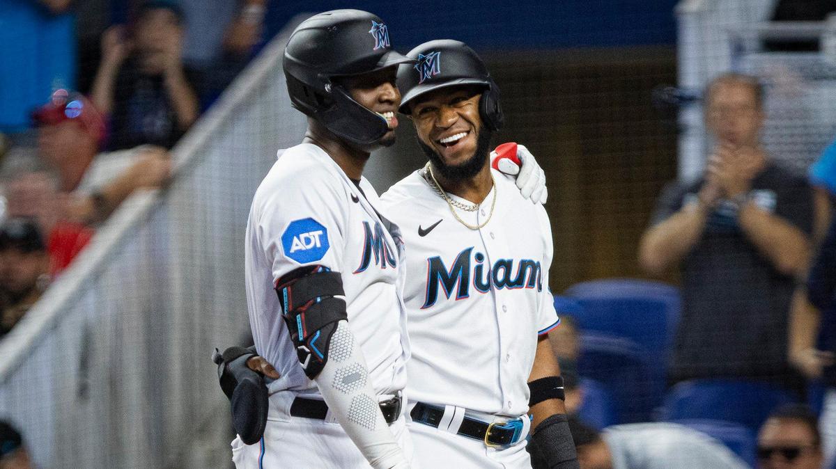 Miami Marlins left fielder Bryan De La Cruz (14) smiles at Miami Marlins right fielder Jesus Sanchez (7) after Sanchez hit a homer getting both of them to score during the first inning of a baseball game on Sunday, July 9, 2023, at loanDepot Park in Miami.