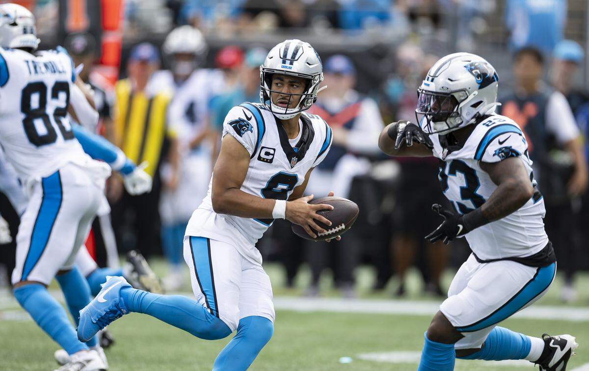 Carolina Panthers quarterback Bryce Young (9) looks to hand the ball to running back Trevor Etienne (23) in the second half of their NFL game against the Miami Dolphins at the Bank of America Stadium on Sunday, Oct. 5, 2025, in Charlotte, N.C.