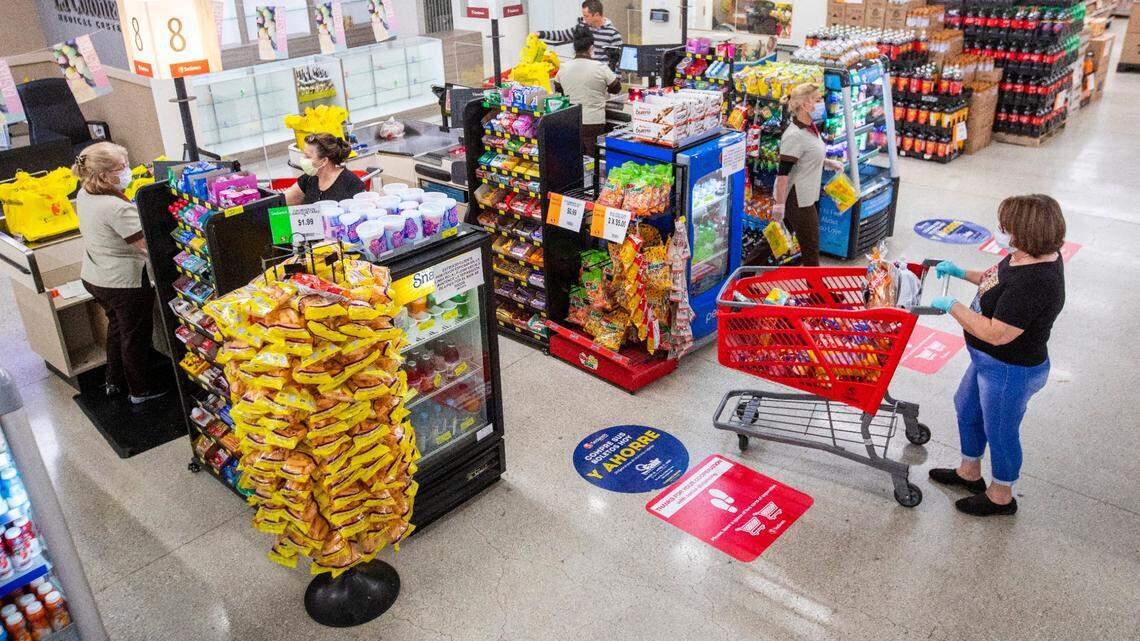 Shoppers maintain six feet of distance between one another as they line up to pay for their groceries at a Sedano’s Supermarket in Hialeah, Florida on Wednesday, April 1, 2020.