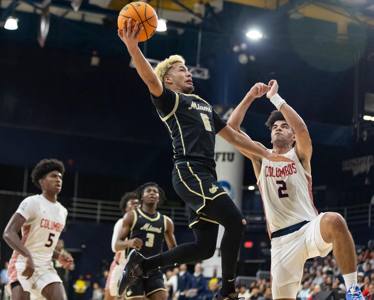 Miami Stingarees Joseph Murillo (0) tries to score as Columbus Explorers Cayden Boozer (2) defends in the first half of their Region 4-7A championship basketball game final at the Ocean Bank Convocation Center on Thursday, Feb. 20, 2025, in Miami, Fla.