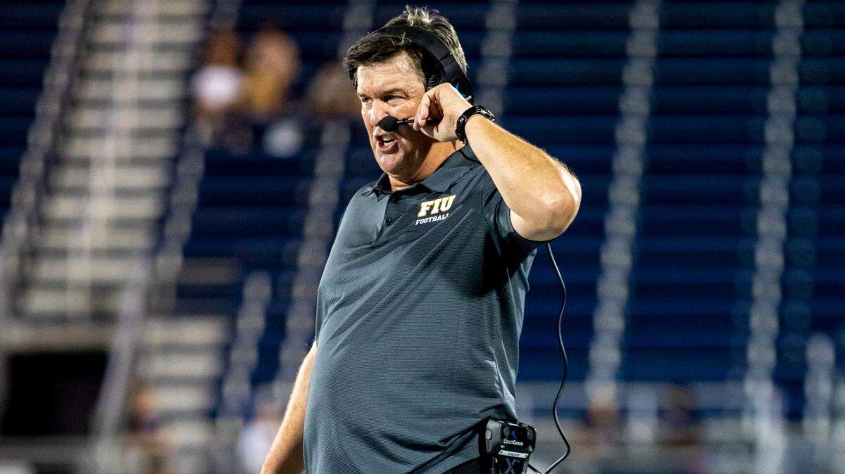 Florida International University head coach Mike Macintyre speaks into his headset while on the sidelines during the second half of an NCAA Conference USA football game against Texas San Antonio at Riccardo Silva Stadium in Miami, Florida, on Friday, September 14, 2022.