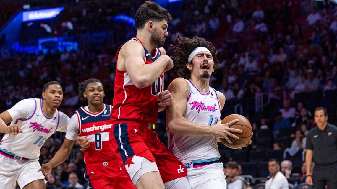 Miami Heat guard Jaime Jaquez Jr. (11) reacts as he steps into the paint while defended by Washington Wizards forward Tristan Vukcevic (00) during the first half of an NBA game at Kaseya Center on April 13, 2025, in Miami.