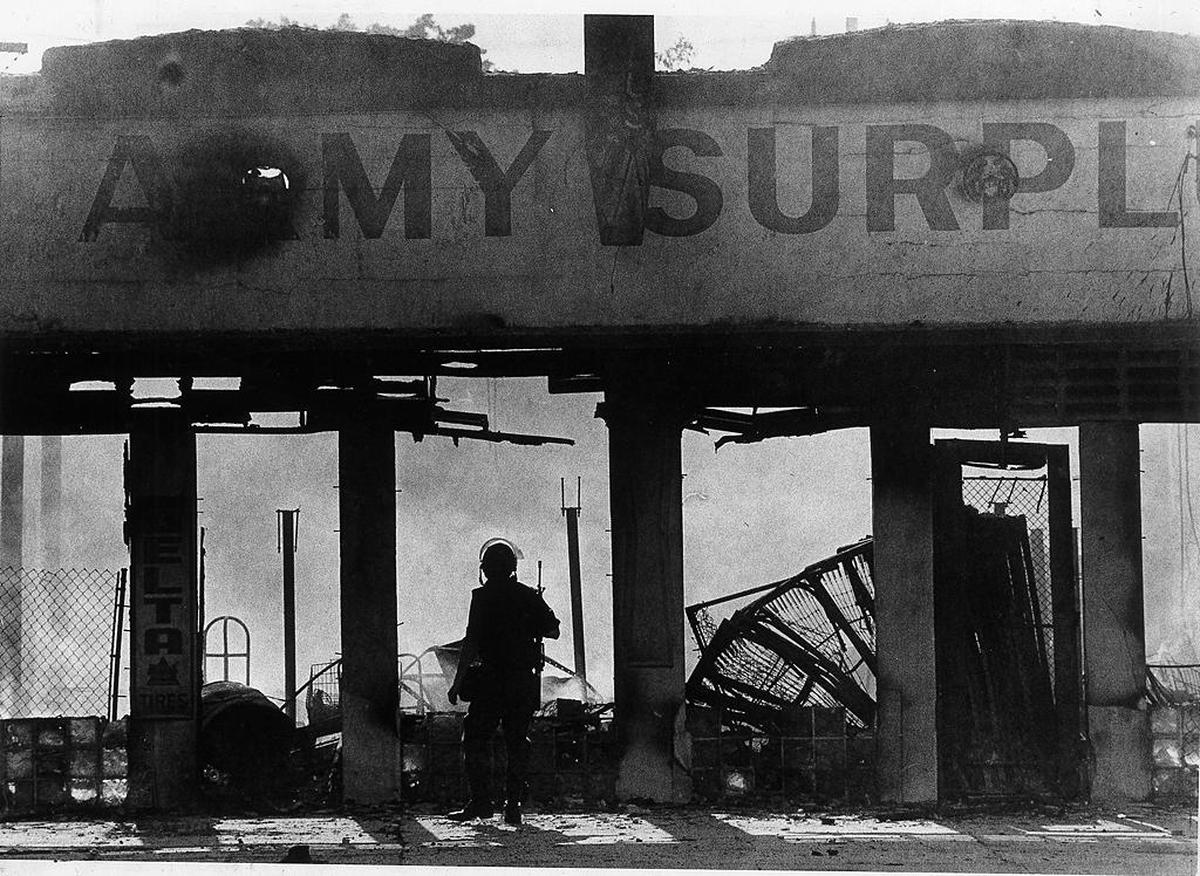 In this file photo from May 19, 1980, an Army Surplus store on Northwest 27th Avenue is in ruins after it was burned during riots after four white police officers were acquitted in the beating death of Arthur McDuffie.
