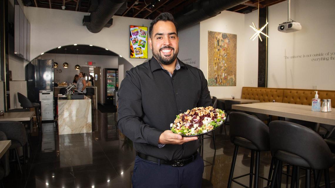 Owner Amin Ebrahimi with a loaded salad at the Shahs of Kabob restaurant in Coral Gables
