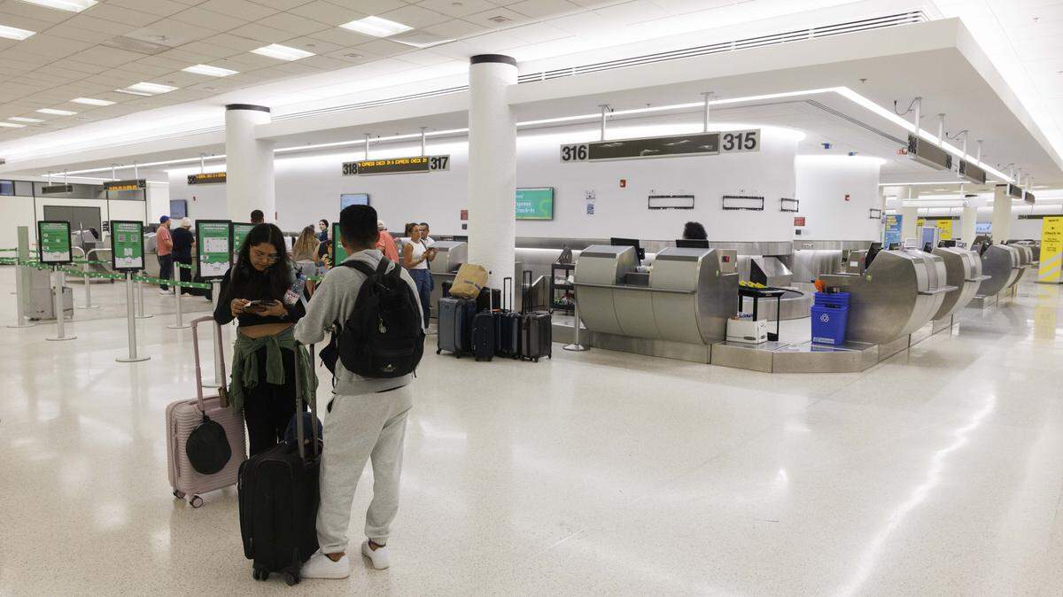 People check in to Viva Aerobus flights at a new ticketing pod in the Central Terminal during the day on Tuesday, Aug. 19, 2025, at the Miami International Airport in Miami, Fla. The airport recently finished construction on three new pods, sections of ticketing counters, in the Central Terminal.